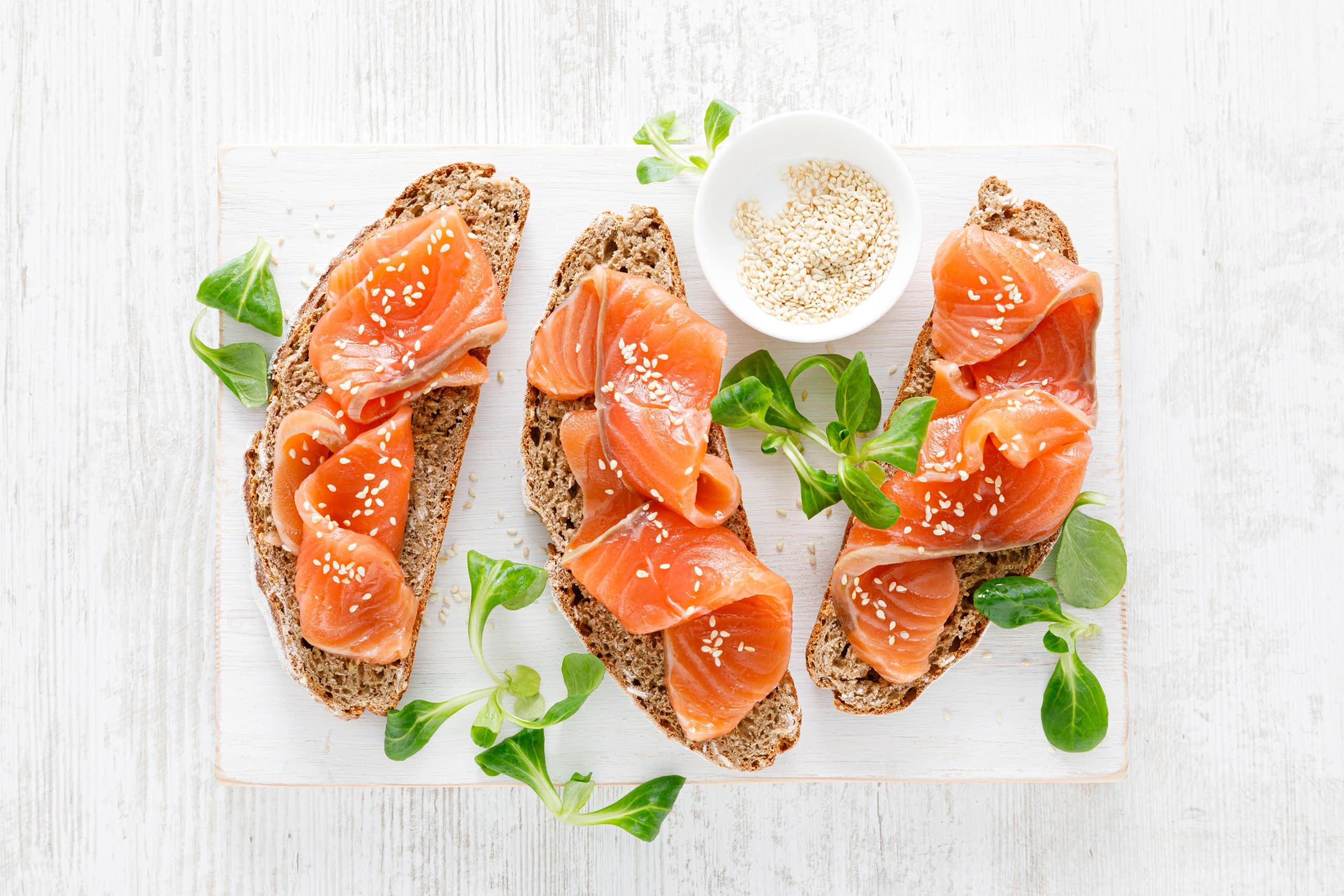 Whole,Grain,Rye,Bread,Open,Sandwiches,With,Salted,Salmon,On